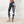 Load image into Gallery viewer, women wearing low waist black and white tie-dye leggings. The leggings are ankle lenght and mae of organic cotton.