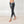 Load image into Gallery viewer, women wearing low waist black and white tie-dye leggings. The leggings are ankle lenght and mae of organic cotton.